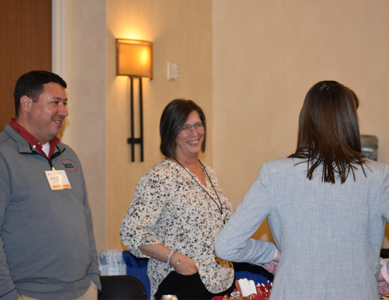 Kyle Young and Carol Neimeyer networking with insurance industry professionals