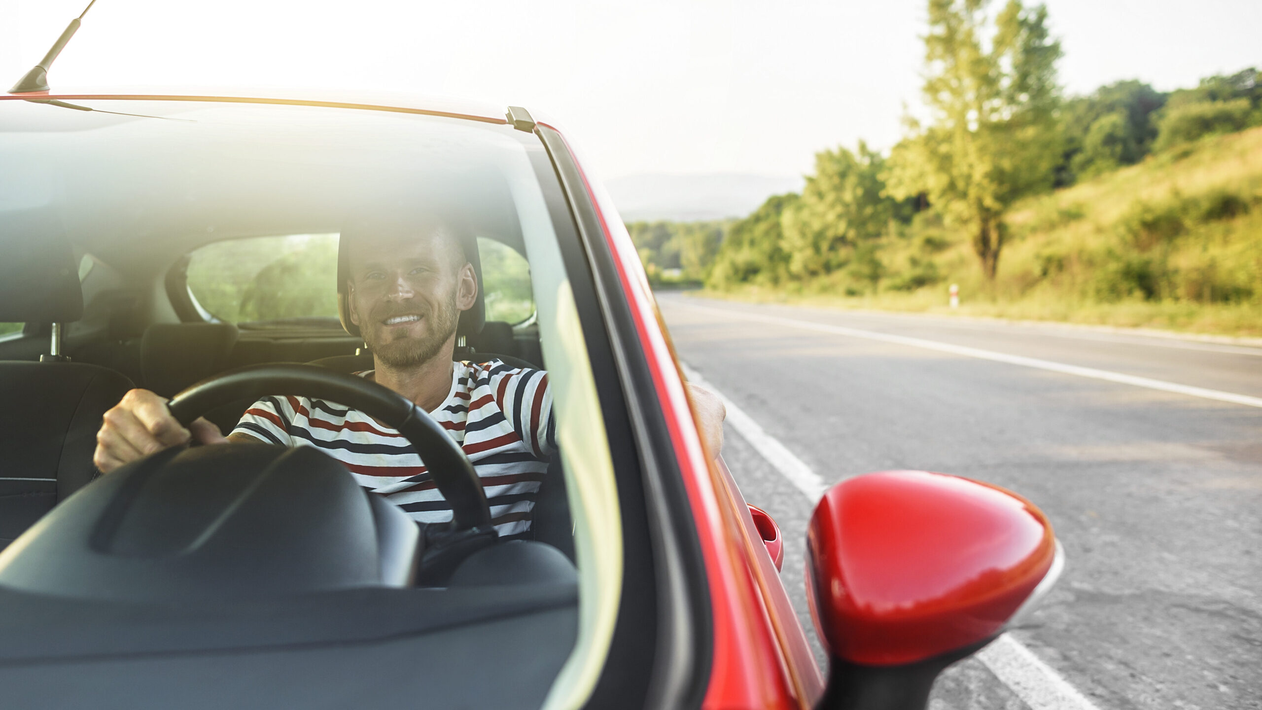 Happy man driving car